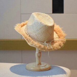 A hand-woven hat with elegant fringes for and top