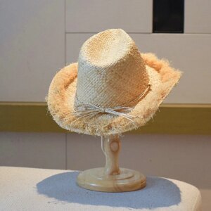 A hand-woven hat with elegant fringes for and top