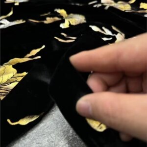 base with gilded silk velvet fabric features a Chinese-style cheongsam dress and clothing