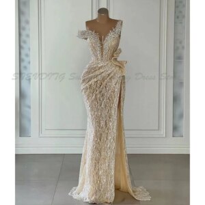 Elegant Champagne Mermaid Prom Dresses Sleeveless V Neck Beaded Appliques Sequins Pearls Floor Length Side Slit Lace Evening