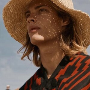A natural handcrafted grass hat made of green foldable and sunshade that is fashionable for vacation