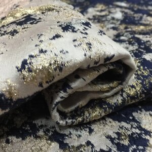 The dress is made of jacquard fabric and brocade featuring golden thread dyed graffiti