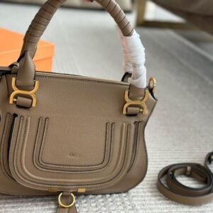 Designer Handheld saddle bag with suede/tassels/rivets/horseshoe buckles incorporating trendy elements!