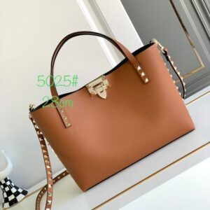 Top of the line cowhide women's tote bag with iconic decorations and detachable shoulder straps that can also be carried by hand