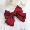 5 satin bow hair clips for sale, with hair accessories on the back of the head